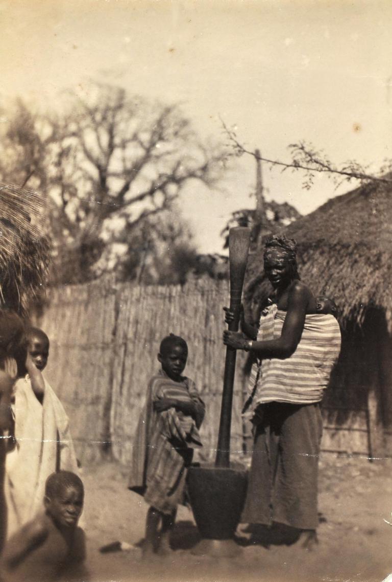 Woman pounding millet, Dakar