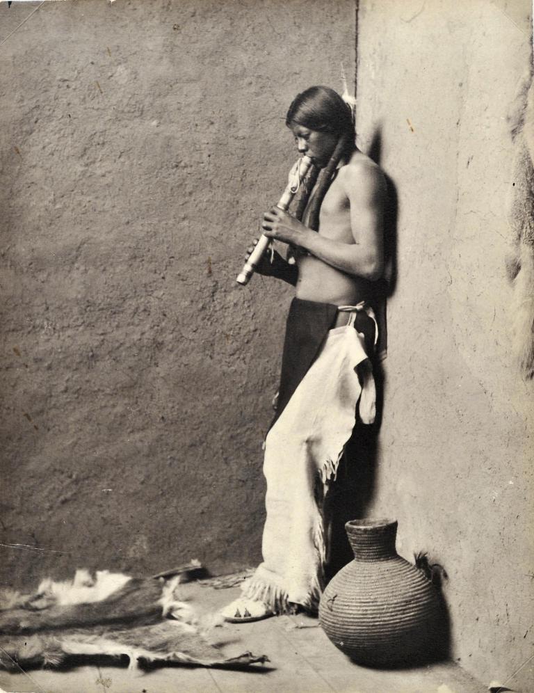 Navajo Indian playing flute
